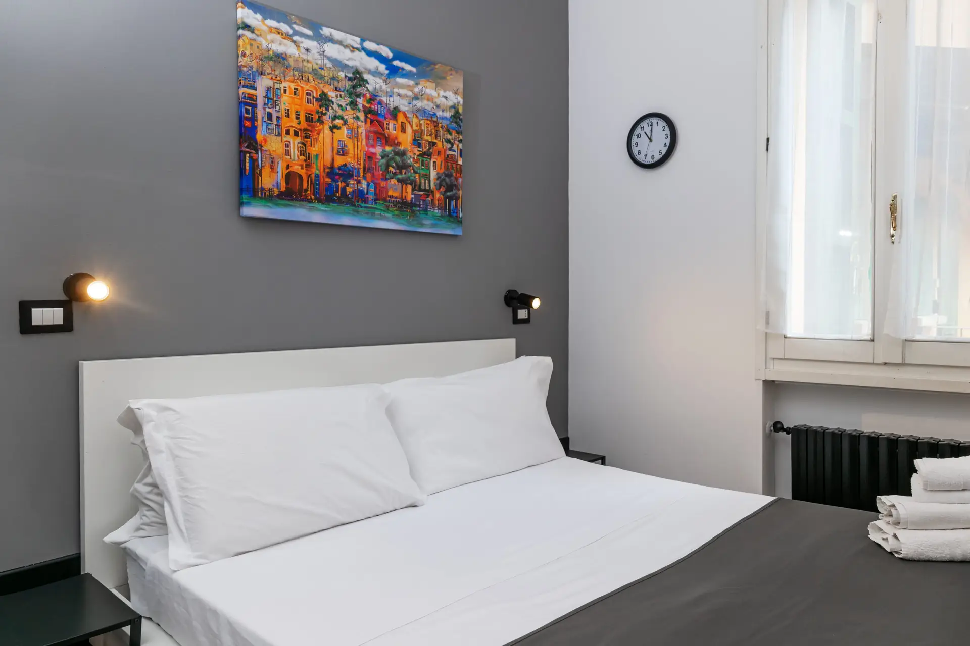 Turati Apartment 2 Modern bedroom with artwork and clock Turati Apartment 2