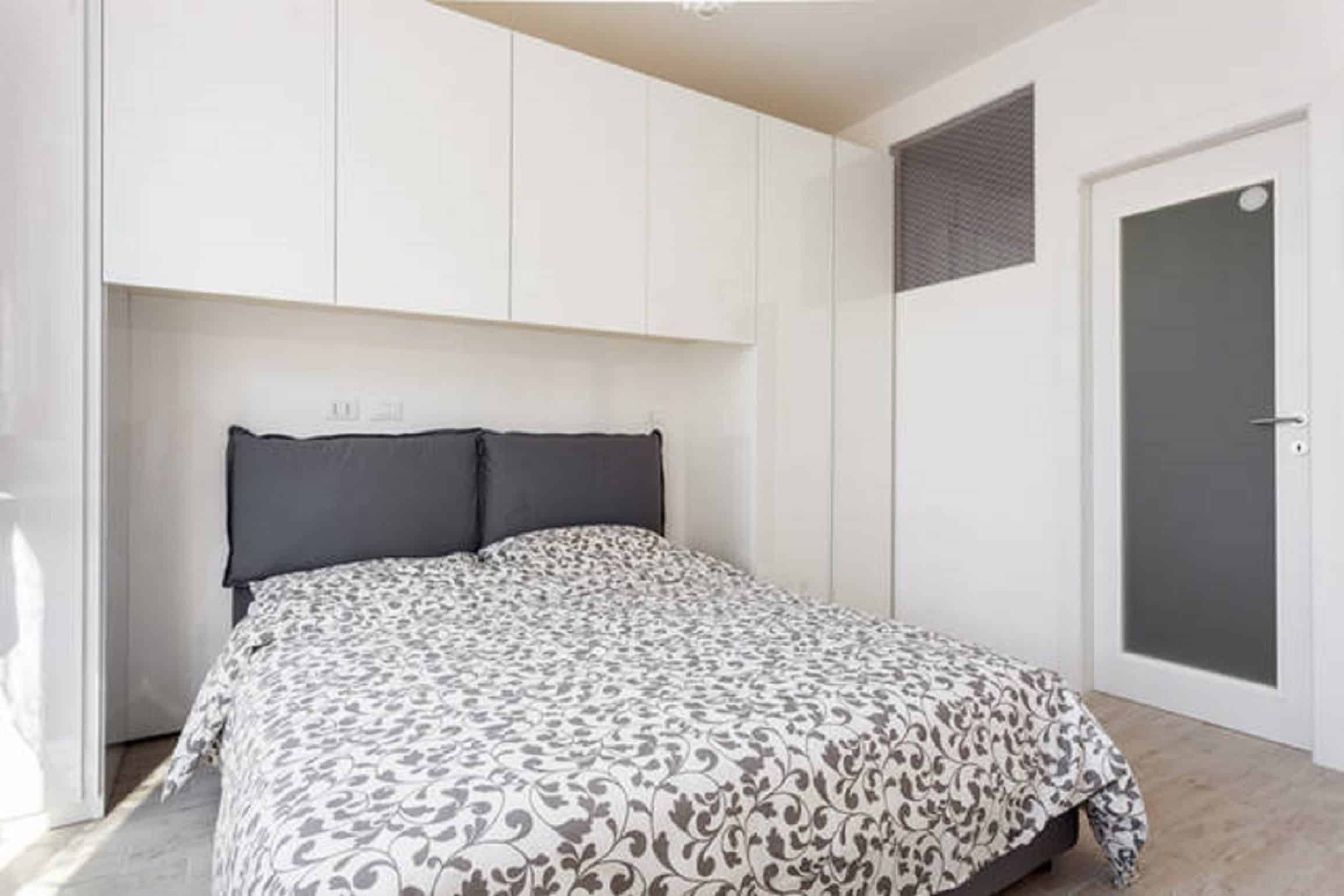Riva Reno Apartment Modern bedroom with patterned bedding - Riva Reno Apartment
