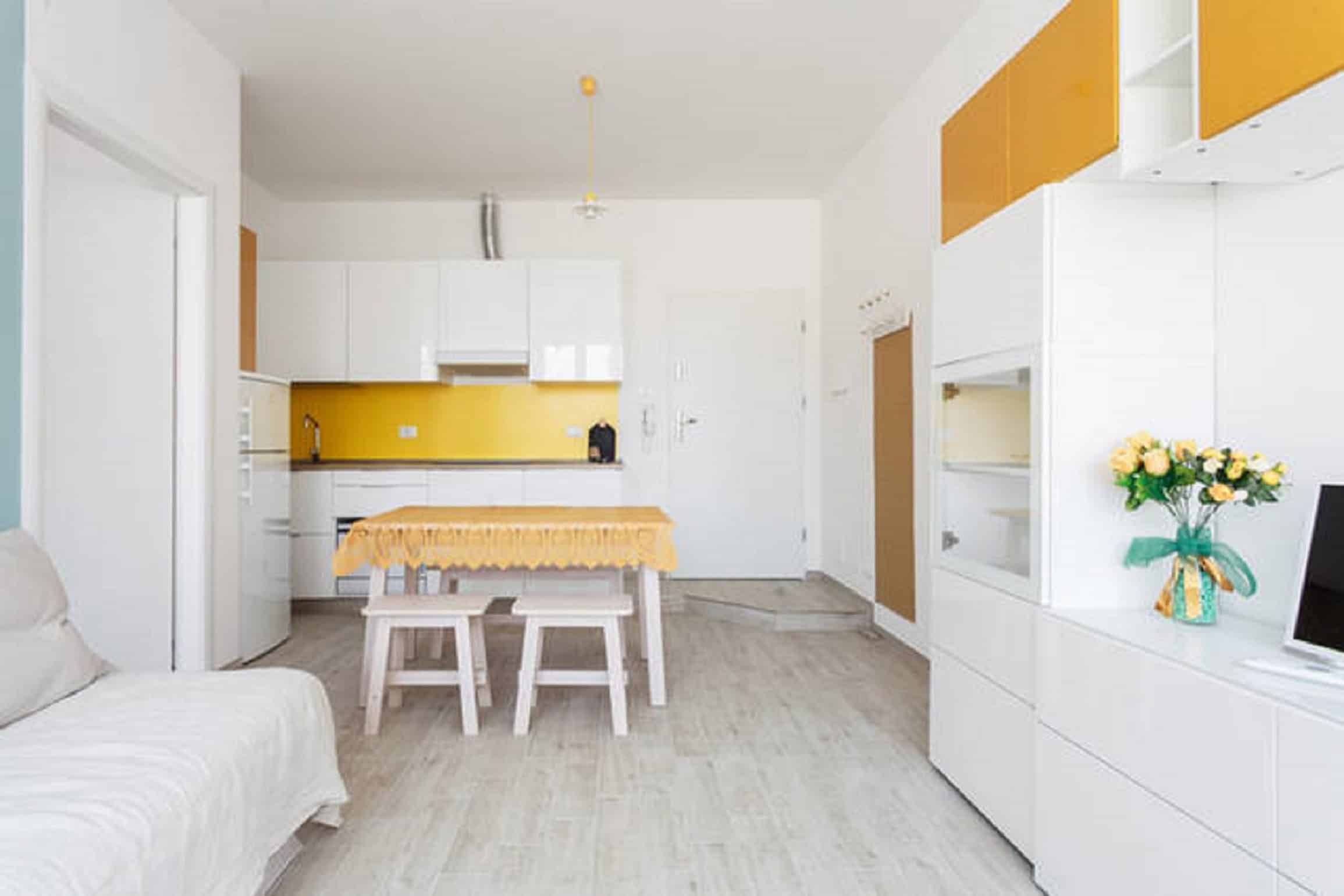 Riva Reno Apartment Modern kitchen with yellow accents - Riva Reno Apartment