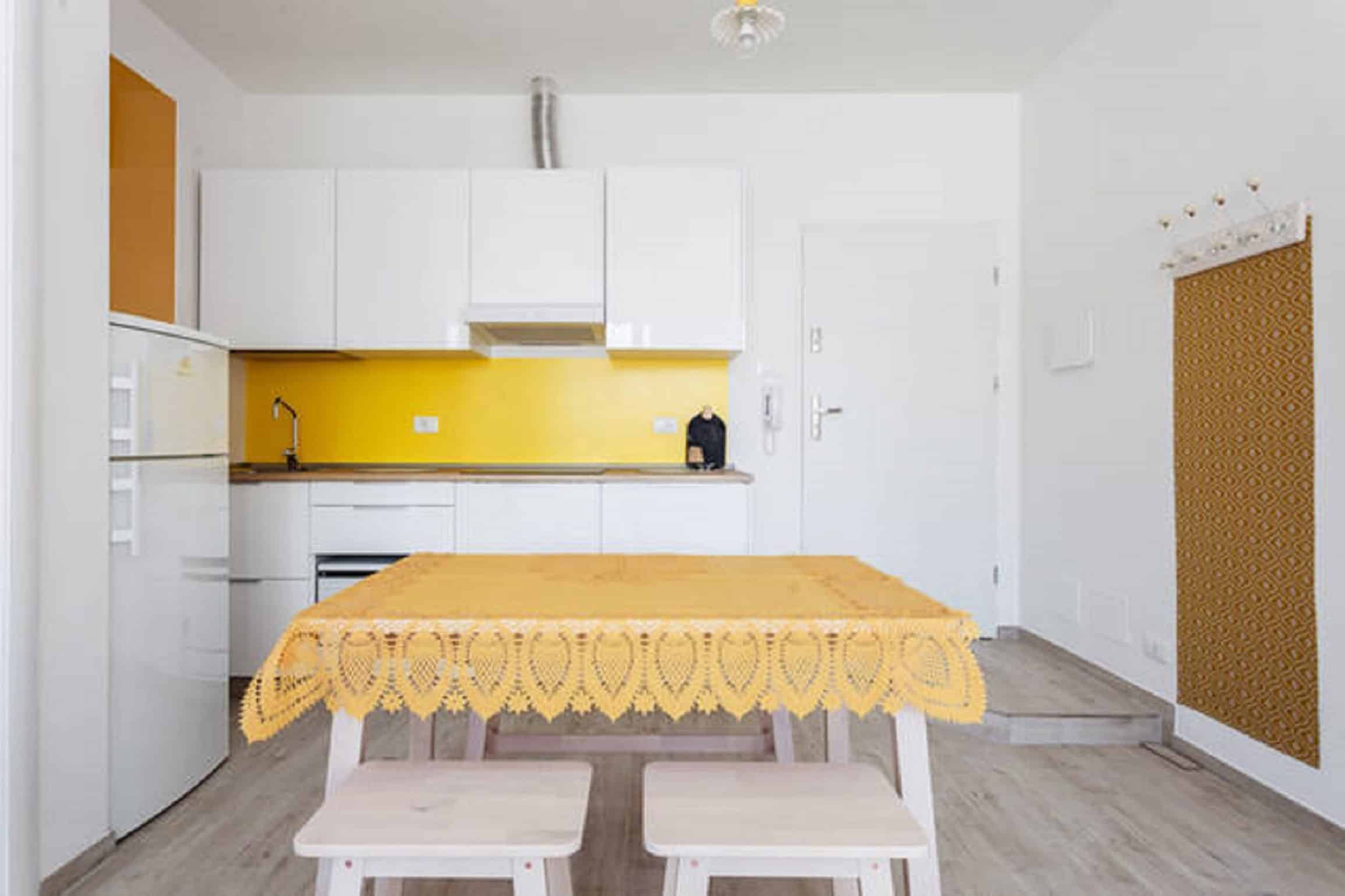 Riva Reno Apartment Modern kitchen with yellow accents - Riva Reno Apartment