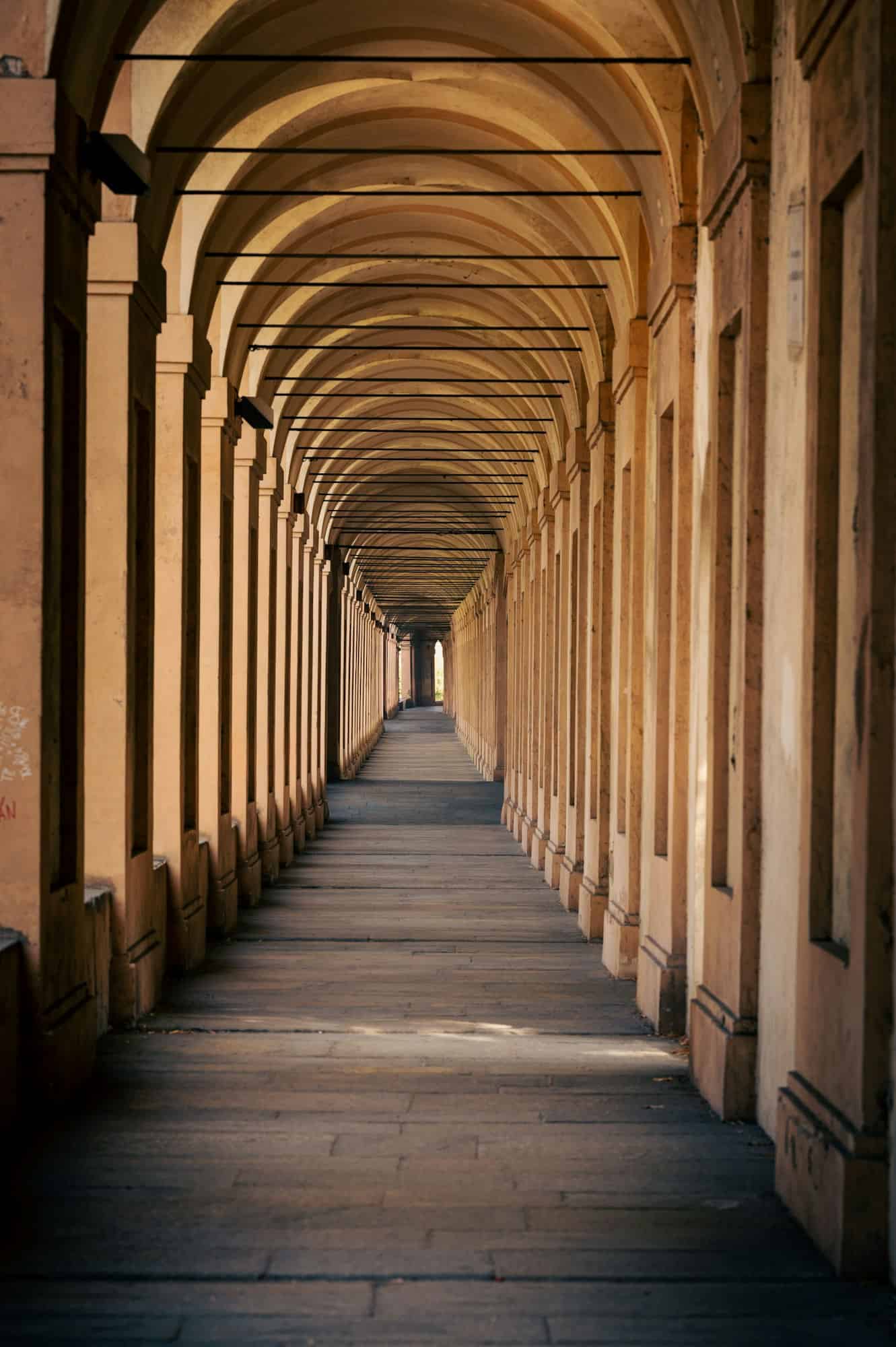 Vertical shot of 666 arches in Portici di Bologna towards Santuario Madonna di San Luca in Italy I portici di Via Saragozza, blog